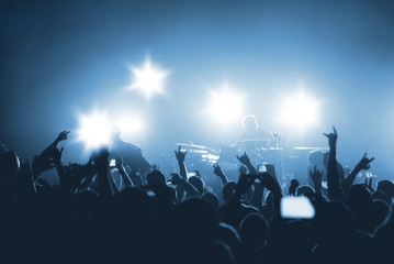 silhouettes of rock musicians on stage. rock concert in a nightclub. silhouettes of the crowd at the music festival.