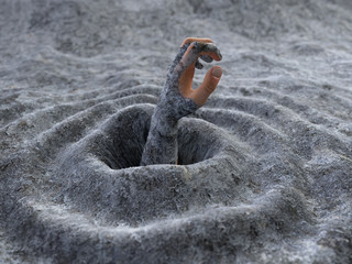 hand of a man sinking in the mud