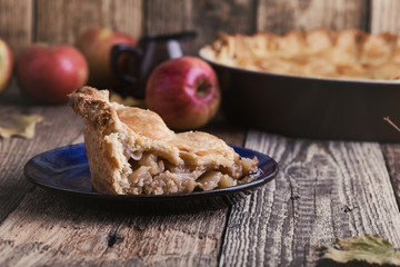 Apple pie with slice  and fresh apples