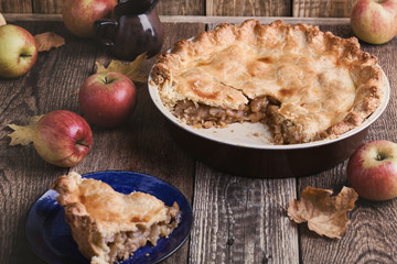Apple pie with slice  and fresh apples