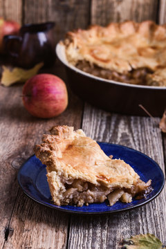 Apple pie with slice  and fresh apples