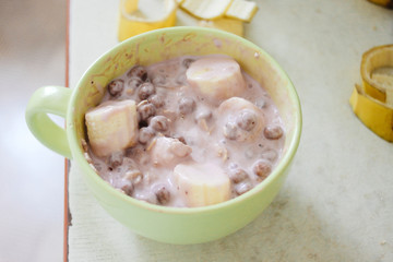morning breakfast bananas yogurt cereals in bowl on old rustic table
