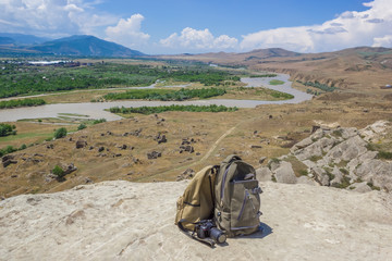 Traveler's travel bag in the background of a mountain landscape
