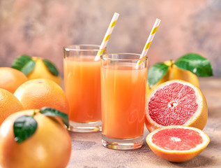 Ripe grapefruits with grapefruit juice on  a abstract  background with copy space.Selective focus.
