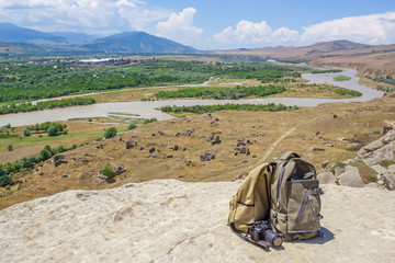 Traveler's travel bag in the background of a mountain landscape