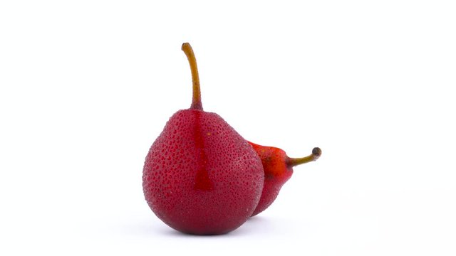 One Whole And One Half Cut Red D'anjou Pears With Water Drops. Rotating On The Turntable Isolated On The White Background. Close-up. Macro.