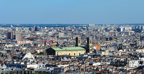 Aerial cityscape of Paris in France, Montmartre, panoramic view. View of Paris from Sacre Coeur Basilica in France in summer day. Roofs in residential quarters. Church of Saint Vincent de Paul