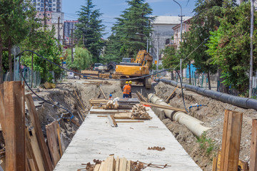 Construction workers renovating road in a big city
