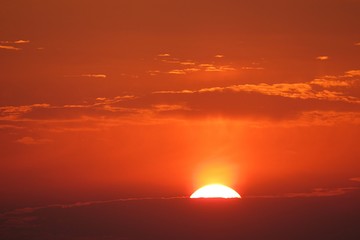 Beautiful orange fiery sunset background over the city, the sun sets below the horizon