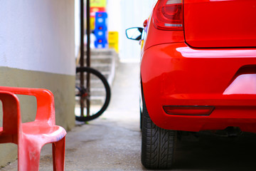 close-up red car stopped with blurred background