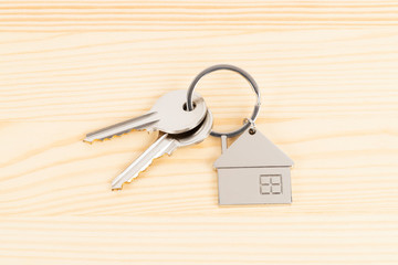 House key on wooden background concept for mortgage