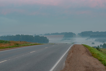 picturesque view of roadway on hill at sunset 
