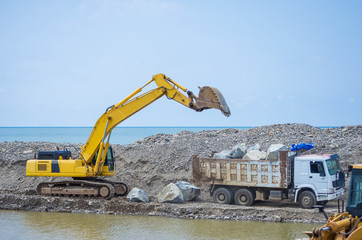 excavator works on the seashore