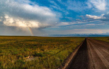 A Desolate Road and a Rainbow after a Rainstorm on the Eastern Plains of Colorado
