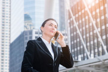 Businesswoman talking on mobile phone in city