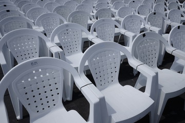 empty white chairs in the square