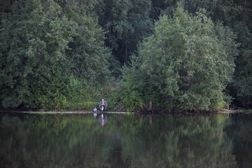 Fototapeta na wymiar Russia,Moscow,- august 18 2018/fisherman on the forest lake - an evening biting
