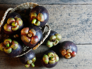 Mangosteen is placed on a wooden table.