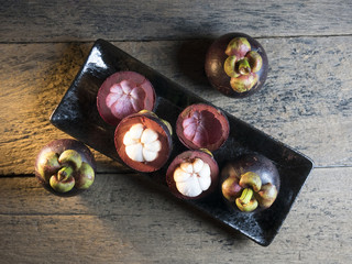 Mangosteen is placed on a wooden table.