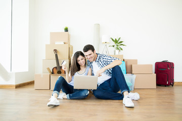 Partners Shopping Online For New Home While Sitting On Floor