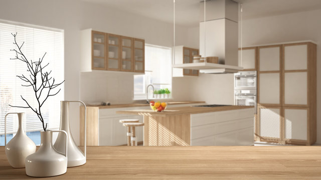 Wooden table top or shelf with minimalistic modern vases over blurred minimalist modern kitchen, white architecture interior design