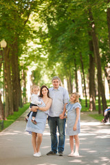 Fototapeta premium Happy family with two kids in the park