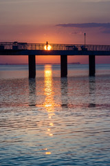 Fototapeta premium People walking on the bridge at sunrise