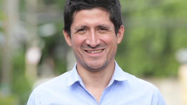 Hispanic businessman smiling outdoors