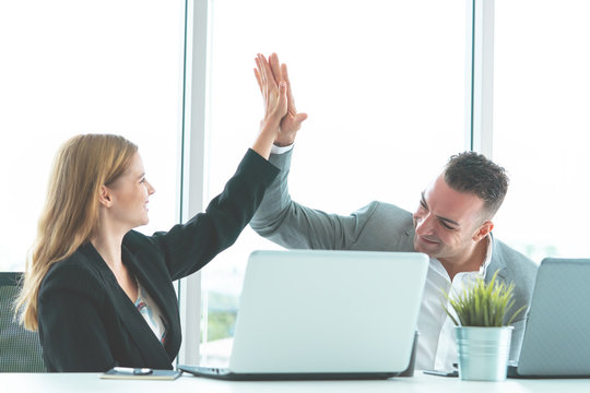 Business Couple Celebrating By Hi Five Together For Business Team Work