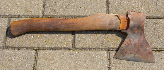 rusty broken axe on tile