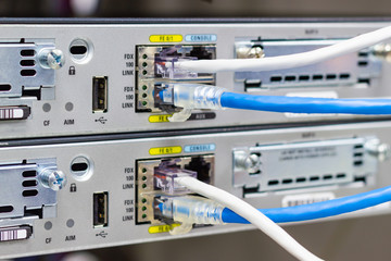 Network switch in rack, network cables connect SFP module port in the Datacenter room, concept Communication technology