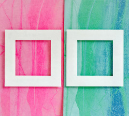 Sheets of colored paper and a white empty frame. Abstract background. Geometric shapes