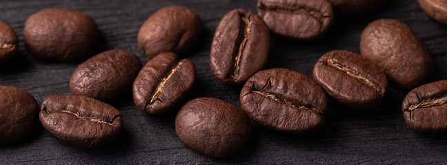 coffee arabica grains scattered on a wooden table