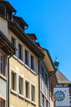 View on the ancient buildings with the Schwabentor clock tower in Freiburg im Breisgau, Germany on a sunny day.