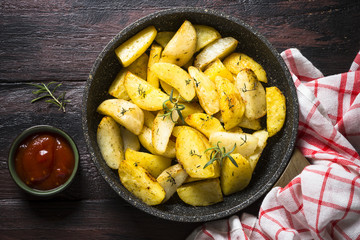 Baked potato with herbs top view.