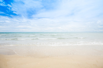Fototapeta na wymiar Beach and sea with white cloud and blue sky background