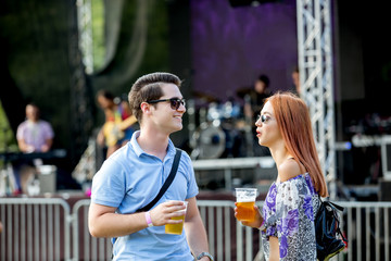 Young couple enjoy in Rock concert on the field