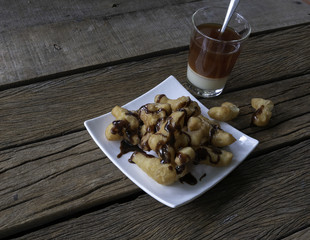 thai or chinese old style hot coffee with patongko placed on