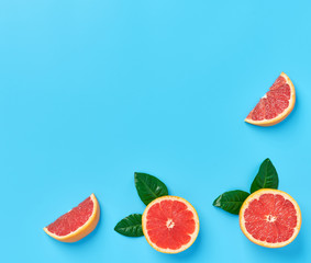 Ripe half of pink grapefruit on a blue background