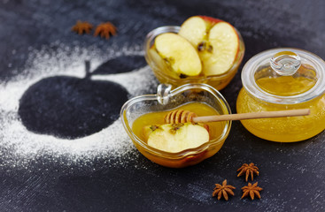 Apple an honey on chalkboard table. Traditional celebration food for the Jewish New Year. Concept of Jewish New Year Rosh Hashanah