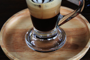 Hot coffee in the glass put on the wood tray.