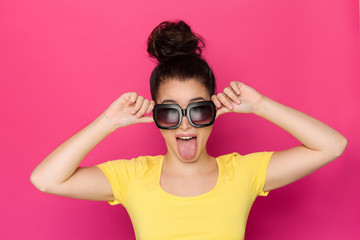 Young Woman In Big Sunglasses Is Stickin Out Tongue