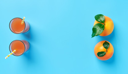 Citrus juice and fruits on a blue background ,top view