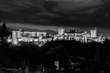 Night cityscape of Granada, Spain, with the Alhambra Palace in the background