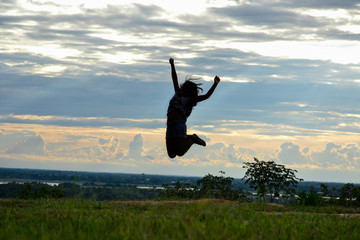 silhouette of a girl jumping in the sunset