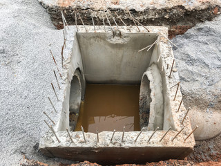 construction contractor installing a sidewalk.Concrete drainage pipe and manhole on construction...