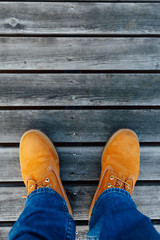 yellow winter boots on wooden planks background