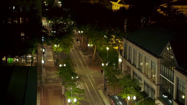 Cars driving down a street at night