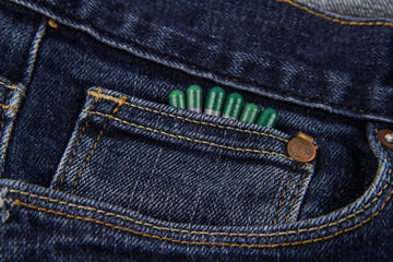 Tablets in a blue jeans pocket