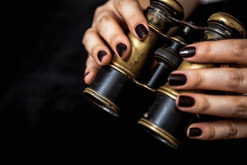 Ancient binoculars in female hands